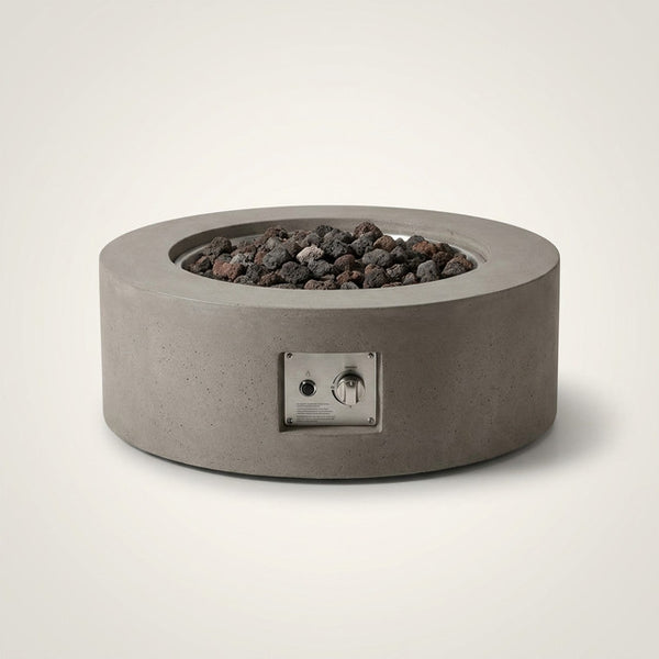 Brookhurst 43 In. W X 13 In. H round Outdoor GFRC Liquid Propane Fire Pit Table in Flint with Lava Rocks — Studio Shot